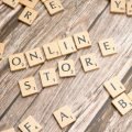 Scrabble tiles spelling 'online store' on a rustic wooden background.